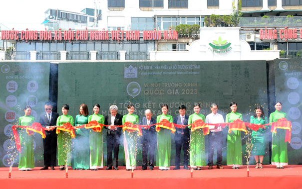 A group of people standing on a red carpetDescription automatically generated