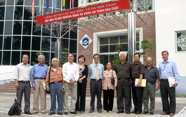 A group of people standing in front of a buildingDescription automatically generated
