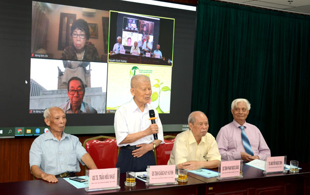 A group of men sitting at a tableDescription automatically generated