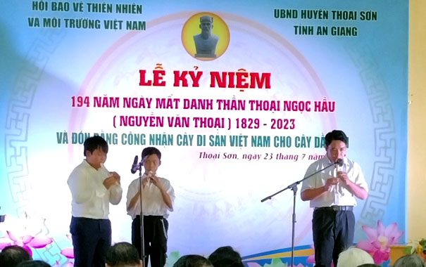 A group of boys singing on a stageDescription automatically generated