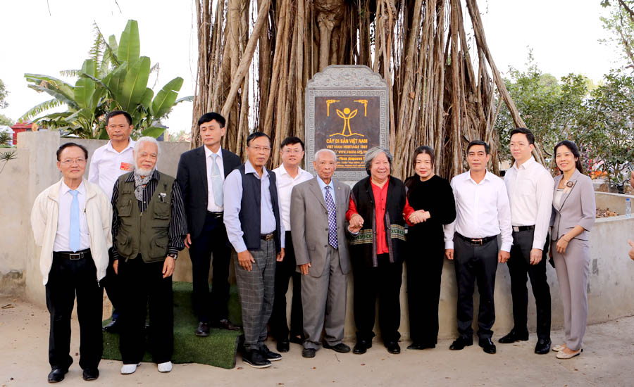 A group of people standing in front of a signDescription automatically generated