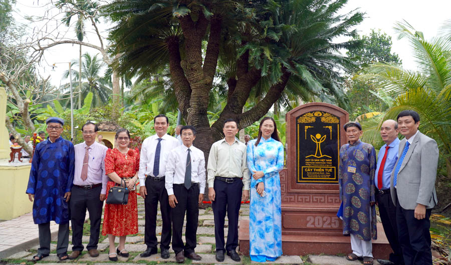 A group of people standing in front of a signDescription automatically generated