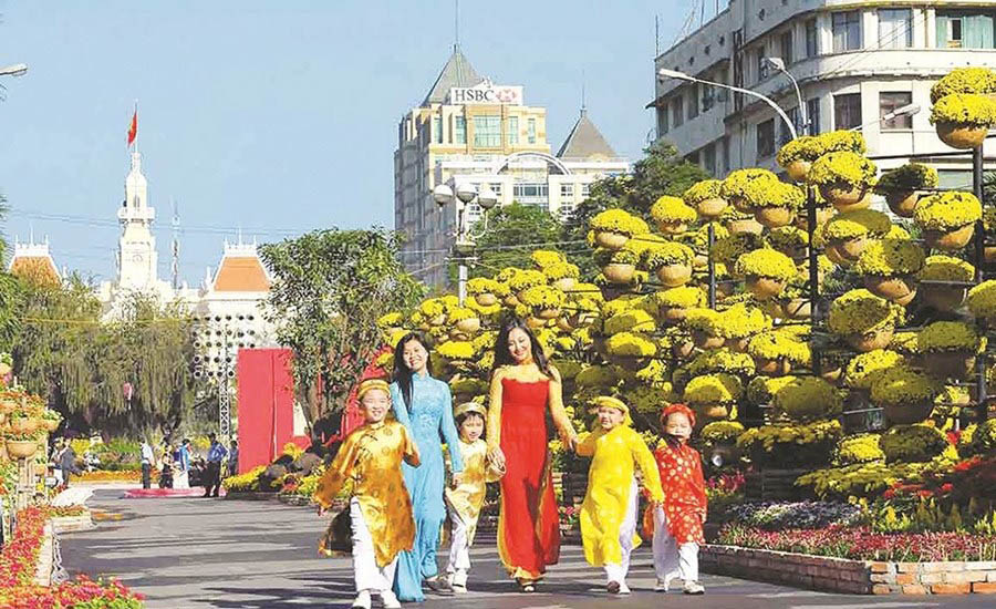 A group of people walking on a streetDescription automatically generated