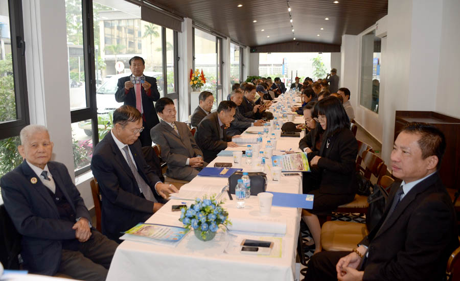 A group of people sitting at a long tableAI-generated content may be incorrect.