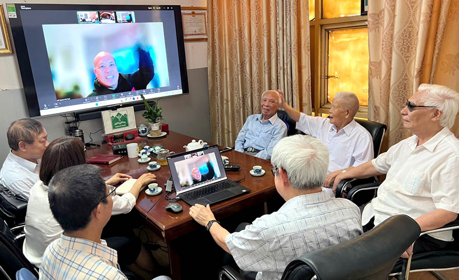 A group of people sitting around a tableAI-generated content may be incorrect.